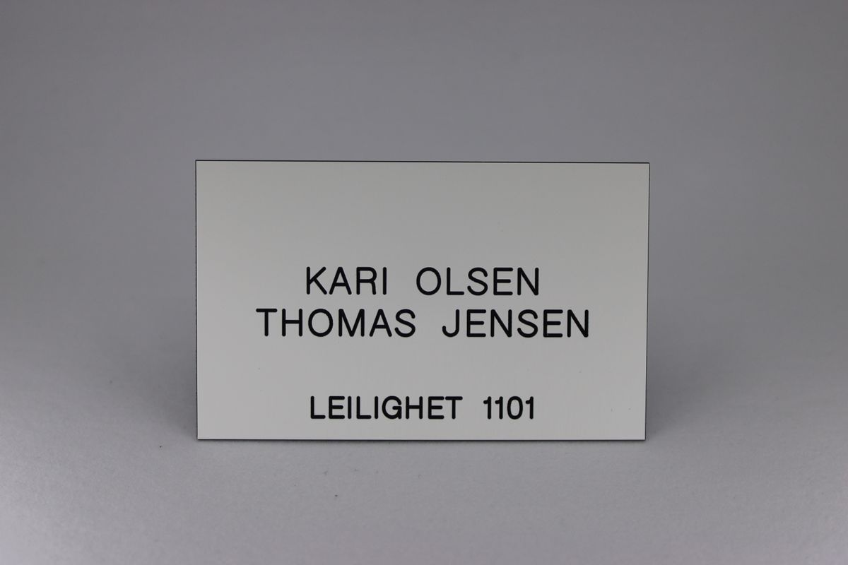 Postkasseskilt Sandbergkassen, hvit plate med svart tekst